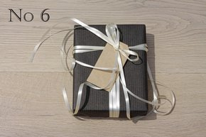 Black Kraft Paper, Gold Curling Ribbon and Natural Gift Tag.